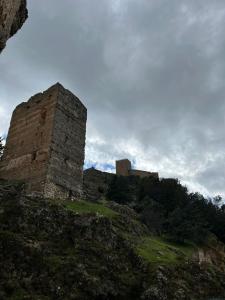 a castle sitting on top of a hill at Alquería de Segur a in Segura de la Sierra