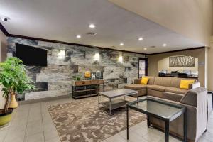 a living room with a couch and a tv at Best Western PLUS University Inn & Suites in Wichita Falls