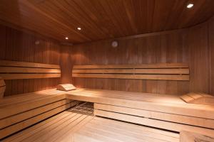 an empty sauna with wooden walls and wooden floors at GHOTEL hotel & living Hannover in Hannover