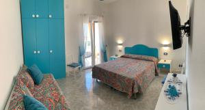 イスキアにあるAppartamenti Tina in Villa Restitutaのベッドルーム(ベッド2台、青いキャビネット付)