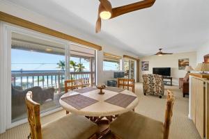 a living room with a table and a view of the ocean at Ocean View 2 Bedroom Kahalu'u Reef in Kailua-Kona