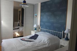 1 dormitorio con cama y espejo grande en Casa breti, en Bretignolles-sur-Mer