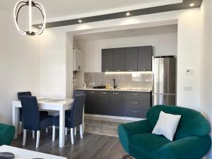 a kitchen with a table and a green couch at Heaven Premium apartments in Sarajevo