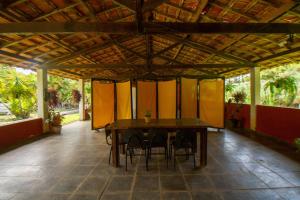 a wooden table and chairs in a room at Estância Canaã Atibaia in Atibaia