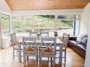 a dining room with a table and chairs at Oak Wood House in Kenmare