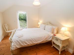 a bedroom with a large bed and a window at Oak Wood House in Kenmare