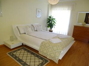 a bedroom with a large bed and a window at Caravela A in Lagos