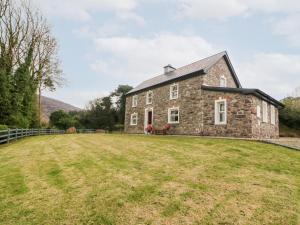 an old stone house with a large yard at Oak Wood House in Kenmare