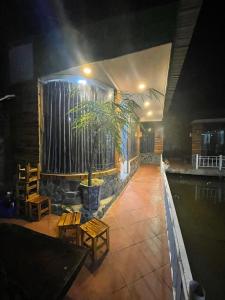 a restaurant with a potted plant in a room at Xu xu motel in Bạc Liêu