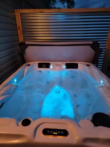 a jacuzzi tub in a backyard at night at Just Dance in Dandridge