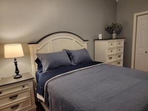 a bedroom with a bed and a lamp and dresser at Just Dance in Dandridge