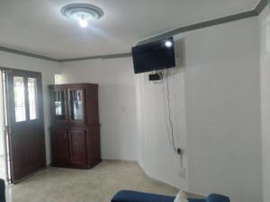 a living room with a tv on a wall at RECIDENCIAL MIGNOLI in Boca Chica