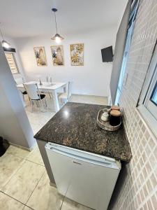 a kitchen with a counter top and a dining room at Bv colon 351 Apart Firmat 2 in Firmat