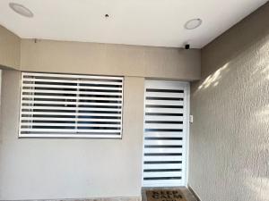 a room with two windows with blinds on them at Bv colon 351 Apart Firmat 2 in Firmat