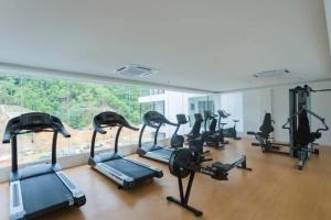 a gym with a bunch of exercise bikes in a room at KK studio [B]/2 Queen Bed/ Netflix/Free Parking in Kota Kinabalu