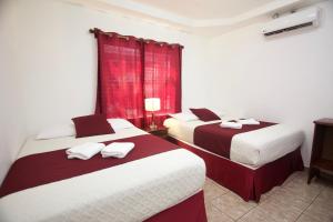 Katil atau katil-katil dalam bilik di Hotel Playa Caribe