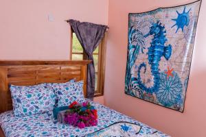 a bedroom with a bed and a painting on the wall at Desired View in Choiseul