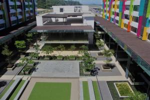 an aerial view of a building with a courtyard at Aeropod [5B]/Near Airport / 2 Queen Bed/ Netflix/Free Parking in Kota Kinabalu
