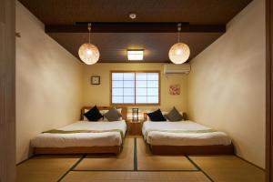 Säng eller sängar i ett rum på Kyoto Villa 3nenzaka by YADORU KYOTO HANARE
