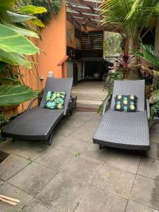 two black chairs with pillows sitting on a patio at LILLI PILLI SUBLIME at the Beach - Family & Dog Friendly in Batemans Bay