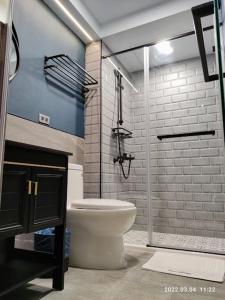 a bathroom with a toilet and a shower at 18世紀普魯士藍現代寓所Prussian Blue Inn工業風 in Kaohsiung