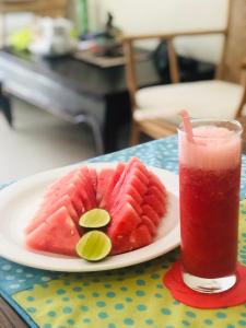 a plate of fruit and a drink on a table at Dream Villa Carissa Seminyak Centre in Seminyak