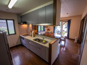 a kitchen with a sink and a counter top at Five Peaks Jigokudani in Shiga Kogen