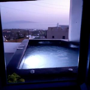a hot tub on the roof of a building at VI STA FINIKIAS VILLA in Oia