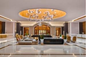 a lobby of a hotel with a large chandelier at Holiday Inn Resort Ho Tram Beach by IHG in Ho Tram