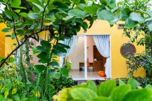 a yellow house with a door and a porch at Binh Minh Eco Lodge in Can Tho +80 photos
