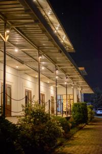 a large white building with lights on it at night at Wisma Amandari in Bandar Lampung