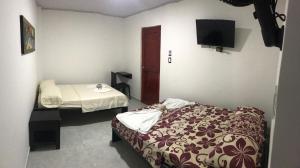 En eller flere senge i et værelse på Hotel Inmaculada Real
