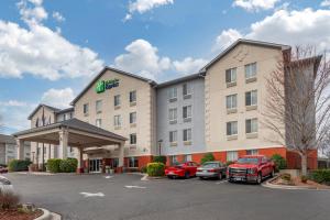 a hotel with cars parked in a parking lot at Holiday Inn Express Charlotte West - Gastonia, an IHG Hotel in Gastonia