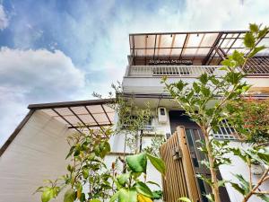 a building with plants on the side of it at Bighem Maison in Izumi-Sano