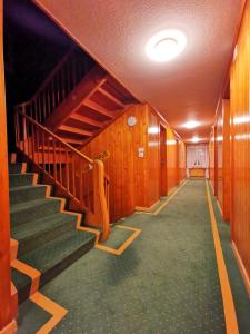 korytarz ze schodami w budynku z drewnianymi ścianami w obiekcie VISP erblick H O T E L AUSSERBERG & Late Check-in w mieście Ausserberg