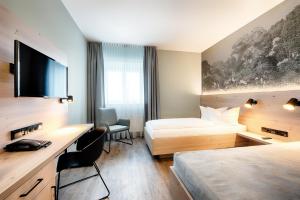 Postel nebo postele na pokoji v ubytování Hotel Sachsen-Anhalt