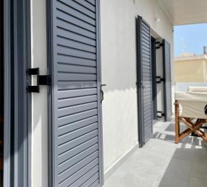 um par de portas numa casa com um pátio em KYRIAKOS APPARTMENT em Monemvasia