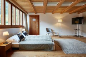 a bedroom with a bed and a table and a chair at Gasthof Krone Blatten in Blatten