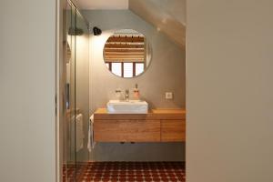 
a bathroom with a sink and a mirror at Gasthof Krone Blatten in Blatten
