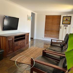 A television and/or entertainment centre at Seashells Holiday House - Kalbarri