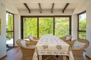 a dining room with a table and wicker chairs at Casa Colina in Albir