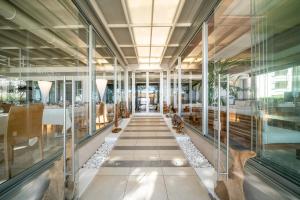 a hallway in a building with glass walls at Hotel Europa in Lignano Sabbiadoro