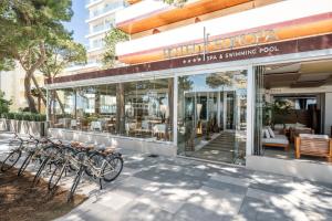 a row of bikes parked outside of a restaurant at Hotel Europa in Lignano Sabbiadoro