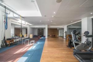 a gym with treadmills and exercise equipment in a room at Anmaria Beach Hotel & Spa in Ayia Napa