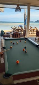 a pool table in front of a beach at Papillon Resort in Chaweng
