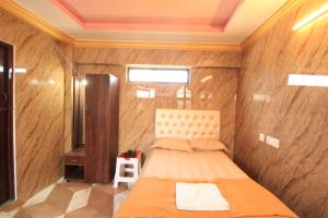 a bedroom with a bed in a room with wooden walls at French Breeze Residency in Pondicherry