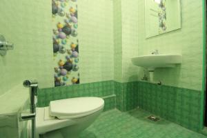 a bathroom with a toilet and a sink at French Breeze Residency in Pondicherry