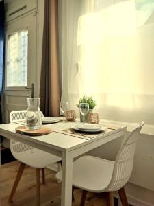 una mesa blanca con 2 sillas y una mesa con gafas en NOUVEAU*Le Bois étoilé*Balnéo*Massage*Détente*Wifi*Netflix*Self-checkin, en Venette