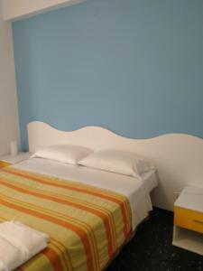 A bed or beds in a room at Albergo Belvedere