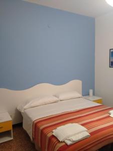 A bed or beds in a room at Albergo Belvedere